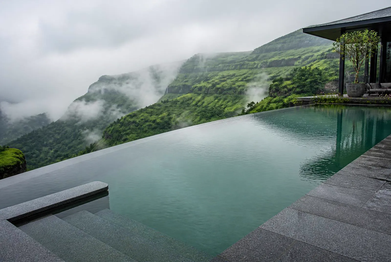 Reinforced membrane liner pool at a Lonavala hill resort in the monsoon mist